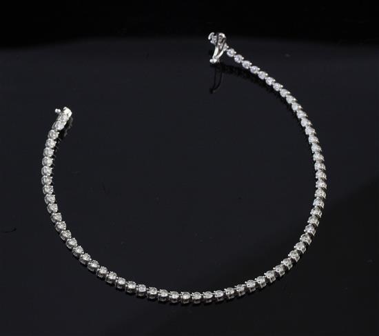 A modern 18ct white gold and diamond line bracelet, 6.75in.